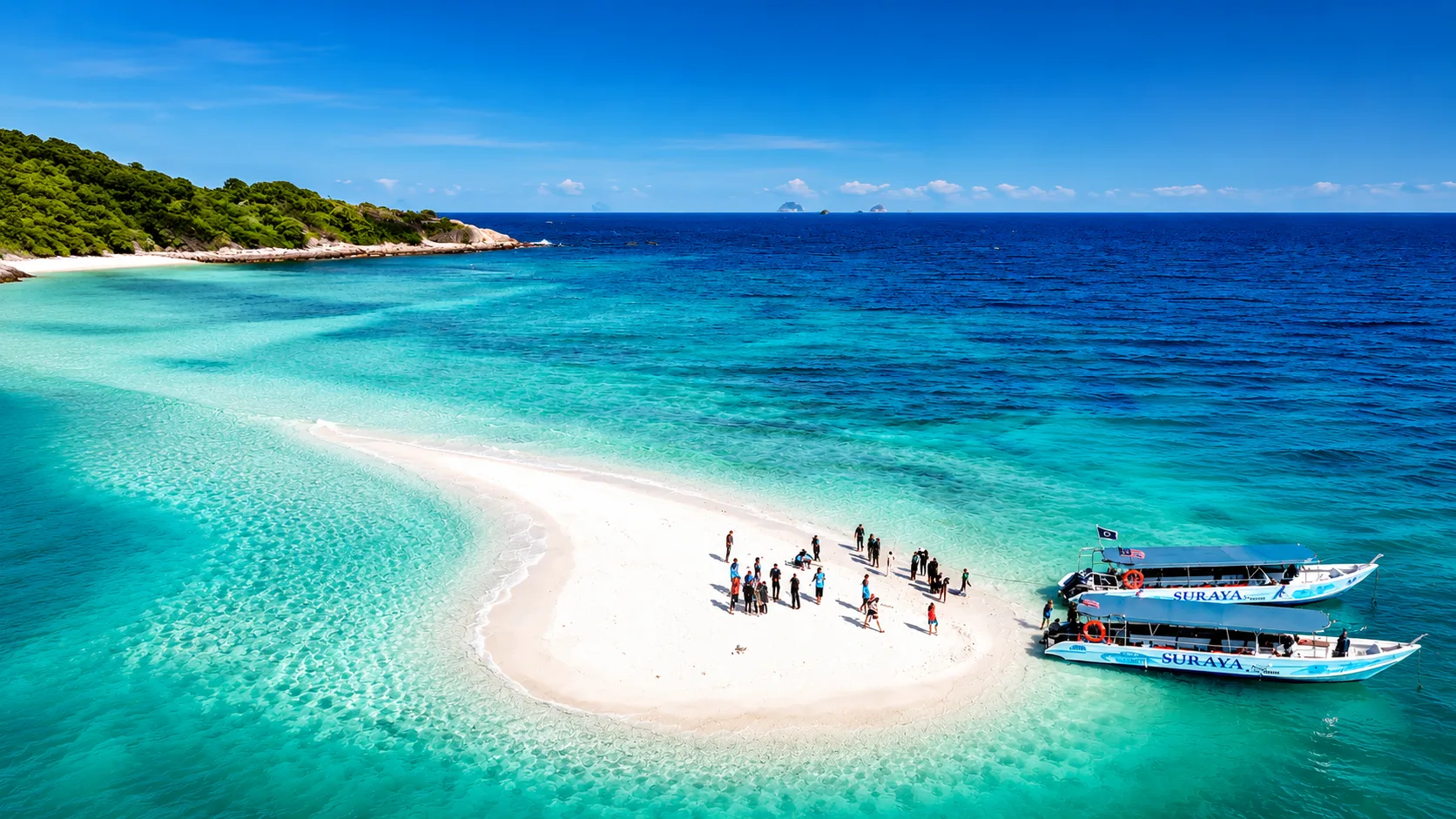 Suraya Redang island tour boat anchored on the crystal clear white sandbar of Redang Island
